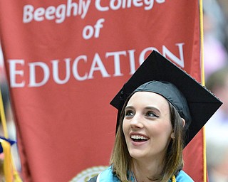 Jeff Lange | The Vindicator  MAY 16, 2015 - Melissa Charles of Liberty smiles back at the crowd as she walks into the Beeghly Center prior to receiving her bachelor degree in Early Childhood Education, Saturday morning at YSU.