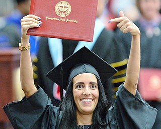 Jeff Lange | The Vindicator  MAY 16, 2015 - Alyssa Testa shows off her bachelors degree of Science in Business Administration to her family in the stands during Saturday morning's commencement ceremony at the Beeghly Center.