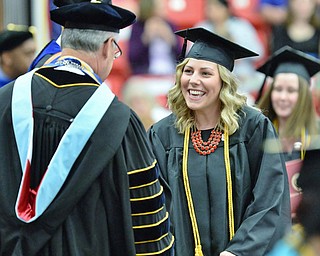 Jeff Lange | The Vindicator  MAY 16, 2015 - Hope Bobonick smiles as she shakes President Jim Tressel's hand after receiving her bachelors of Science in Education, Saturday morning during YSU's commencement ceremony at the Beeghly Center.