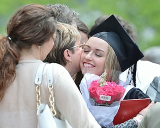Jeff Lange | The Vindicator  MAY 16, 2015 - Ashley Bowers (right) hugs her aunt Paulette McKay of Austintown after Saturday morning's commencement ceremony at YSU. Bowers received her bachelors degree in engineering.