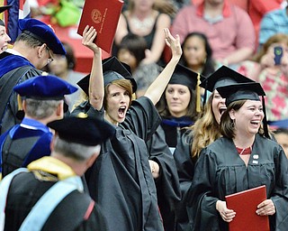 Jeff Lange | The Vindicator  MAY 16, 2015 - Renee Kathryn White (center) holds her arms up victoriously after receiving her masters in social work during Saturday afternoon's commencement ceremony at the Beeghly Center in Youngstown.