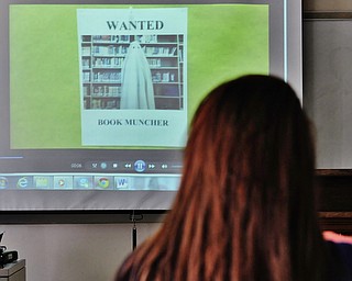 Jeff Lange | The Vindicator  MAY 11, 2015 - A student in Mrs. Adrienne Lesnett's Young Adult Literature Class watches the class' video titled "Groovy Groo and the Book Muncher."