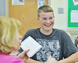 Jeff Lange | The Vindicator  MAY 11, 2015 - West Branch sophomore Jordan Brown laughs as he explains his process of editing the video for the class, Monday afternoon at West Branch High School.