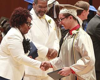 William D. Lewis The Vindictor YEC valedictorian Damon McDowell gets diploma from YEC Dean Monica Jones. center is Rev William Blake, Director of the office of Diversity at YSU who was was speaker at YEC graduation sunday at DeYor.