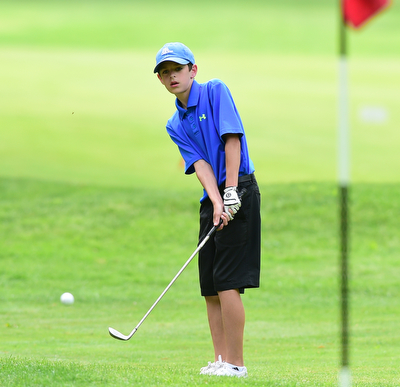 VIENNA, OHIO - MAY 17, 2015: Dean Austalosh of Campbell chips from the short rough onto the green on the 4th hole Sunday afternoon at Squaw Creek Country Club during the Vindy Greatest Golfer junior qualifier. (Photo by David Dermer/Youngstown Vindicator)