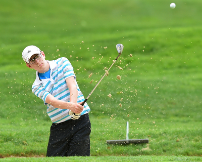 VIENNA, OHIO - MAY 17, 2015: Zavier Bokan of McDonald chips out of the bunker and onto the green on the 4th hole Sunday afternoon at Squaw Creek Country Club during the Vindy Greatest Golfer junior qualifier. (Photo by David Dermer/Youngstown Vindicator)