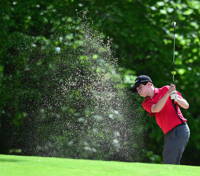 VIENNA, OHIO - MAY 17, 2015: Michael Butch chips out of the bunker and onto the green on the 13th hole Sunday afternoon at Squaw Creek Country Club during the Vindy Greatest Golfer junior qualifier. (Photo by David Dermer/Youngstown Vindicator)