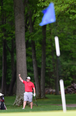 VIENNA, OHIO - MAY 17, 2015: Joey Shushok of Austintown raises his arm in celebration after his golf ball dropped into the hole for a eagle on the par 416th hole Sunday afternoon at Squaw Creek Country Club during the Vindy Greatest Golfer junior qualifier. (Photo by David Dermer/Youngstown Vindicator)