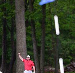 VIENNA, OHIO - MAY 17, 2015: Joey Shushok of Austintown raises his arm in celebration after his golf ball dropped into the hole for a eagle on the par 416th hole Sunday afternoon at Squaw Creek Country Club during the Vindy Greatest Golfer junior qualifier. (Photo by David Dermer/Youngstown Vindicator)