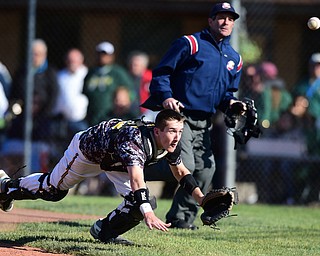 STRUTHERS, OHIO - MAY 22, 2015: Catcher Bryce James #5 of South Range unsuccessfully attempts to dive and catch a pop up in foul ground in the bottom of the 1st inning during Friday evenings game at Cene Park. Ursuline won 13-3. (Photo by David Dermer/Youngstown Vindicator)