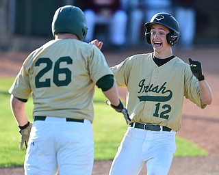 STRUTHERS, OHIO - MAY 22, 2015: Base runner Gianni Quattro #12 of Ursuline celebrates with teammate Brice Bokesch #26 after crossing home plate to score the game winning run in the bottom of the 6th inning during Friday evenings game at Cene Park. Ursuline won 13-3. (Photo by David Dermer/Youngstown Vindicator)