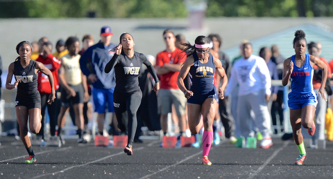 Jeff Lange | The Vindicator  MAY 22, 2015 - Harding's Chyna Stroud (far left) and Justice Richardson (left) sprint down the track against Solon's Lauren McCoy and Ravenna's Chanavier Robinson in the women's 100 meter dash during Friday's DI district track meet at Fitch HS.