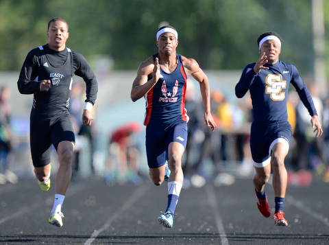 Jeff Lange | The Vindicator  MAY 22, 2015 - East's LeAndre Green (left) and Fitch's Joe Harrington (center) sprint down the tack in the 100 meter dash against Solon's Darryl Sinclair during Friday's DI district track meet at Fitch HS.