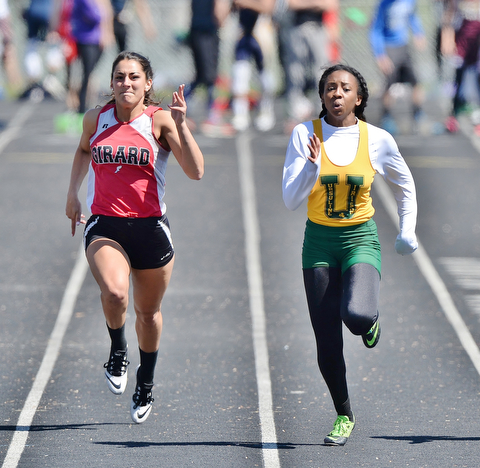 Jeff Lange | The Vindicator  MAY 23, 2015 - Girard's Caitlyn Trebella (left) and Ursuline's Alexandra Cantata sprint down the track in the girls 100 meter dash during Saturday's DII district track finals at Lakeview High School. Ursuline's Carnatha placed first with a time of 12.71 seconds while Girard's Trebella placed fifth with a time of 13.15 seconds.