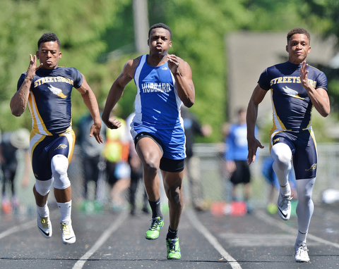 Jeff Lange | The Vindicator  MAY 23, 2015 - Hubbard's George Hill (center) competes in the boys 100 meter dash against Streetsboro's Prince Franklin (left) and Dakar Carter (right) during Saturday's DII district track finals at Lakeview High School. Hubbard's Hill placed second with a time of 11.06 seconds.