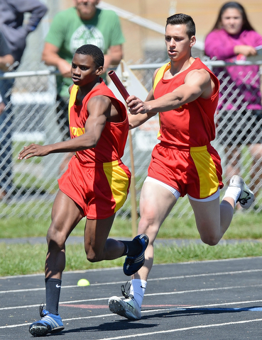 Jeff Lange | The Vindicator  MAY 23, 2015 - Mooney's Syied Bowers (left) takes the handoff from Luke Pecchia during the boys 4x200 meter relay at the DII district finals at Lakeview High School, Saturday. Mooney's 4x200 team placed fourth in the event with a time of 1:34.38.
