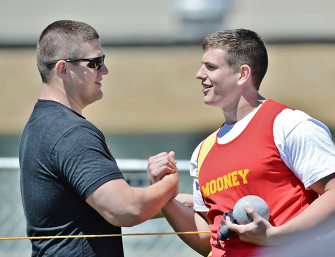 Jeff Lange | The Vindicator  MAY 23, 2015 - Mooney senior Dante Penza (right) is congratulated after his stadium record breaking throw of 58 feet 9.75 inches by his personal throwing coach and former stadium record holder Nick Panezich of Springfield. Panezich set the record in 2004 with a throw of 57 feet 7.75 inches.