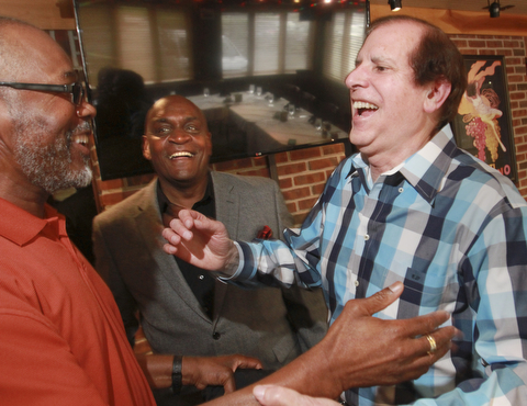 William D. Lewis the Vindicator Mark Purfey, former scoutmaster of Troop 18 in Youngstown, reacts upon seeing 2 of his former scouts Vincent M. Smith and Rev. Gary Frost during a 50 year reunion held Sunday 5-24-15 at Springfield Grill in Boar dman.