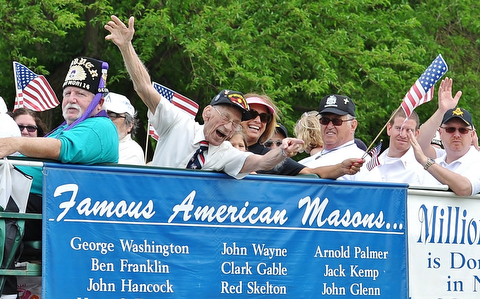 Jeff Lange | The Vindicator  MAY 25, 2015 - Jim Giles also known as Slim Jim of Aut Mori Grotto leans over the railing of the Masons float in Monday's Memorial Day Parade in Boardman.