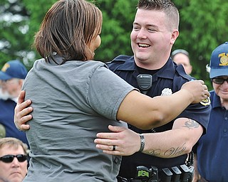 Jeff Lange | The Vindicator  MAY 25, 2015 - Boardman police officeer Nick Newline (right) smiles as he embraces Francine McDaniel of Boardman when Marine Corps veterans were recognized during Monday's Memorial Day ceremony at Boardman Park. Newline and McDaniel are both veterans of the U.S. Marine Corps and have known each other since Newline was an eighth grader at Boardman Middle School.