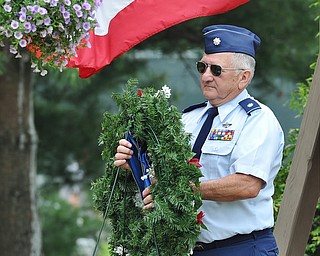 Jeff Lange | The Vindicator  MAY 25, 2015 - Lt. Col. Bill Moss, retired Air Force veteran carries the wreath to honor those who have fallen during Monday's Memorial Day ceremony at Boardman Park.