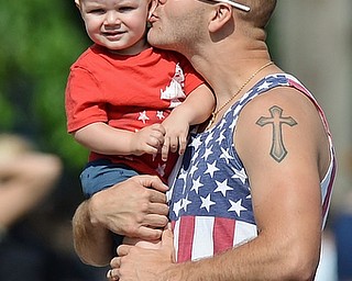 Jeff Lange | The Vindicator  MAY 25, 2015 - Rick Lape (right) plants a kiss on his 17 month old nephew Jake Lape Jr. while waiting for the Memorial Day parade, Monday morning on U.S. 224 in Boardman.