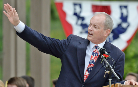 Jeff Lange | The Vindicator  MAY 25, 2015 - Mark Luke of Boardman Kiwanis recognizes the Memorial Day speaker Paul Rossi prior to calling him to the podium to deliver his message, Monday morning at Boardman Park.