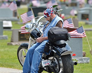 Jeff Lange | The Vindicator  MAY 25, 2015 - Joe Dempsey of Newton Falls has a moment of remembrance as he reviews and sends photos to his relatives of his grandfathers grave, Monday afternoon at the Cemetery in Newton Falls. Dempsey's grandfathers were World War II combat veterans.