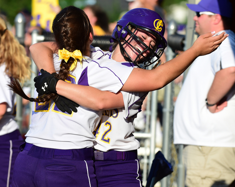 MASSILLON, OHIO - MAY 27, 2015: Amber Ricci #42  of Champion is hugged in the dugout by teammate Haylee Gardiner #22 after she scored the tying run in the bottom of the 7th inning during Wednesday nights Regional Semi-Final game at Massillon High School. Champion won 6-5 in 9 innings. (Photo by David Dermer/Youngstown Vindicator)