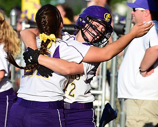 MASSILLON, OHIO - MAY 27, 2015: Amber Ricci #42  of Champion is hugged in the dugout by teammate Haylee Gardiner #22 after she scored the tying run in the bottom of the 7th inning during Wednesday nights Regional Semi-Final game at Massillon High School. Champion won 6-5 in 9 innings. (Photo by David Dermer/Youngstown Vindicator)