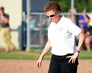 MASSILLON, OHIO - MAY 27, 2015: Head coach Cheryl Weaver of Champion retains to the 3rd base coaches box after a conference with a player during Wednesday nights Regional Semi-Final game at Massillon High School. Champion won 6-5 in 9 innings. (Photo by David Dermer/Youngstown Vindicator)