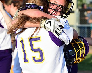 MASSILLON, OHIO - MAY 27, 2015: Brittany Allen #6 of Champion hugs teammate Megan Turner #15 after bottom of the 9th inning during Wednesday nights Regional Semi-Final game at Massillon High School. Champion won 6-5 in 9 innings. (Photo by David Dermer/Youngstown Vindicator) .Allen hit the game winning single, Turner scored game winning run.