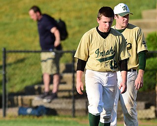 MASSILLON, OHIO - MAY 28, 2015: Alex Schlosser #18 and Drew Potesta #3 of Ursuline walk on the infield after the post game hand shake after Thursday nights game at Massillon High School. (Photo by David Dermer/Youngstown Vindicator)