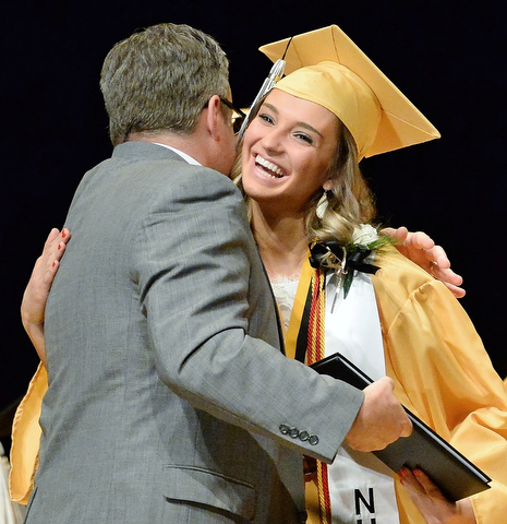 Jeff Lange | The Vindicator  MAY 28, 2015 - Harding honor student Kaitlyn Annandono (right) expresses her joy in receiving her diploma as she walks across the stage during Thursday evening's commencement ceremony at Packard Music Hall in Warren.