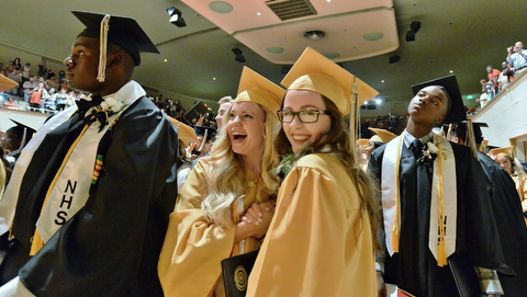 Jeff Lange | The Vindicator  MAY 28, 2015 - Harding honor students Meredith Brugler (left) and Mackenzie Annadono (right) hold hands in excitement after turning their tassels during Thursday's commencement at Packard Music Hall in Warren.
