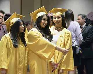 Katie Rickman | The Vindicator.Susan Amireh on left smiles as her cousin Rosie Amireh holds her cell phone up for a photo using a "selfie stick" Kae Thompson also smiles prior to the Liberty High School commencement ceremony at Stambaugh Auditorium.