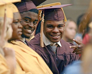 Katie Rickman | The Vindicator.Alexander Treyvon Carnathan gives the peace sign as his classmate Leslie Howard Carter III smiles during the Liberty High School commencement ceremony at Stambaugh Auditorium.
