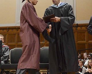 Katie Rickman | The Vindicator.Ernest Anthony Amabile Turner shakes hands with David Malone as he received his diploma at the Liberty High School commencement ceremony at Stambaugh Auditorium.