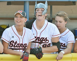 Jeff Lange | The Vindicator  MAY 28, 2015 - Stangs' Cheyenne Eggens (center) dawns a Thor helmet in dugout as she cheers for teammates. Moments later Eggens would hit a two-run homer to center in the bottom of the fourth inning, Thursday afternoon at Kent State University.