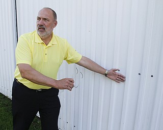        ROBERT K. YOSAY  | THE VINDICATOR..30th of the tornado -..pastor  Rob McFarland at Chestnut Ridge Church Of God- shows the damage to the side of the steel  that was damaged on the church