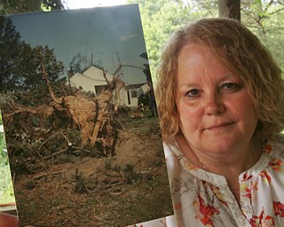 William D. Lewis The Vindicator  Joyce Dripps lwith a photo from 1985 tornado at her Collar PriceRd. home in Hubbard Twp. The home was damaged in the 1985 tornado.