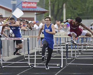 Katie Rickman | The Vindicator.Bryan Partika of Poland Seminary, center, jumps the last hurdle winning 2nd place as Doug Rutana of Poland Seminary (on left) and Anthony Thurman race along side him at the Division 2 Region 5 Track Meet at Austintown Fitch High School. ..