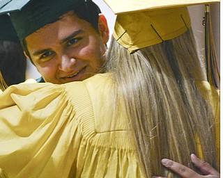 Katie Rickman | The Vindicator.Ursuline graduations Ryan Lalchand and Frances Glodek embrace prior to the one-hundred-seventh Ursuline High School commencement at Stambaugh Auditorium on May 30, 2015.