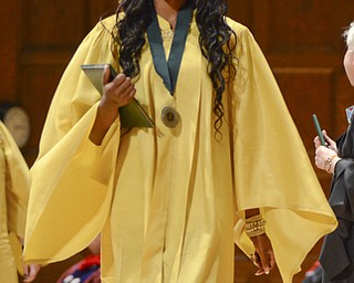 Katie Rickman | The Vindicator.Precious Williams smiles as she walks across the stage after receiving her diploma at the one-hundred-seventh Ursuline High School commencement at Stambaugh Auditorium on May 30, 2015.