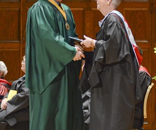 Katie Rickman | The Vindicator.Sean McGuire shakes hands with Ursuline Principal Patricia Fleming at the one-hundred-seventh Ursuline High School commencement at Stambaugh Auditorium on May 30, 2015.