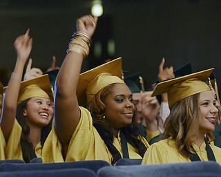 Katie Rickman | The Vindicator.Students raise their hands and smile after turning their tassels during the one-hundred-seventh Ursuline High School commencement at Stambaugh Auditorium on May 30, 2015.