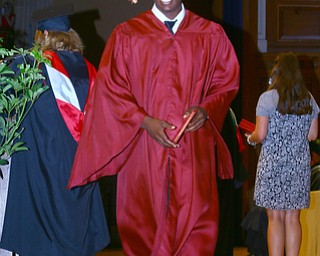 Mike Capps | The Vindicator.Mooney student Atiim Smith happily receives his diploma today at Stambaugh before a packed auditorium..