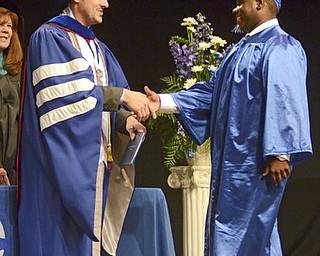 Katie Rickman | The Vindicator.Collin Nicholas Wilkins shakes hands with Mike Pecchia at the Youngstown Christian School graduation at Highway Tabernacle on May 31, 2015.