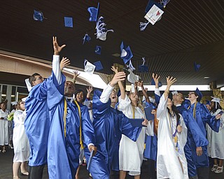 Katie Rickman | The Vindicator.A group of Youngstown Christian School graduates excitedly throw their graduation caps following the commencement ceremony at Highway Tabernacle on May 31, 2015.