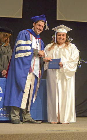 Katie Rickman | The Vindicator.Alisia De'Lia Rivera shakes hands with Mike Pecchia while receiving her diploma at the Youngstown Christian School graduation at Highway Tabernacle on May 31, 2015.